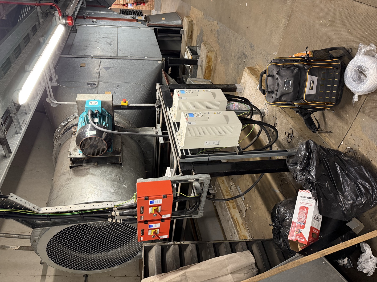 Plant room showing two ABB ACH580 drives beside an axial extract fan with Brook Crompton motor