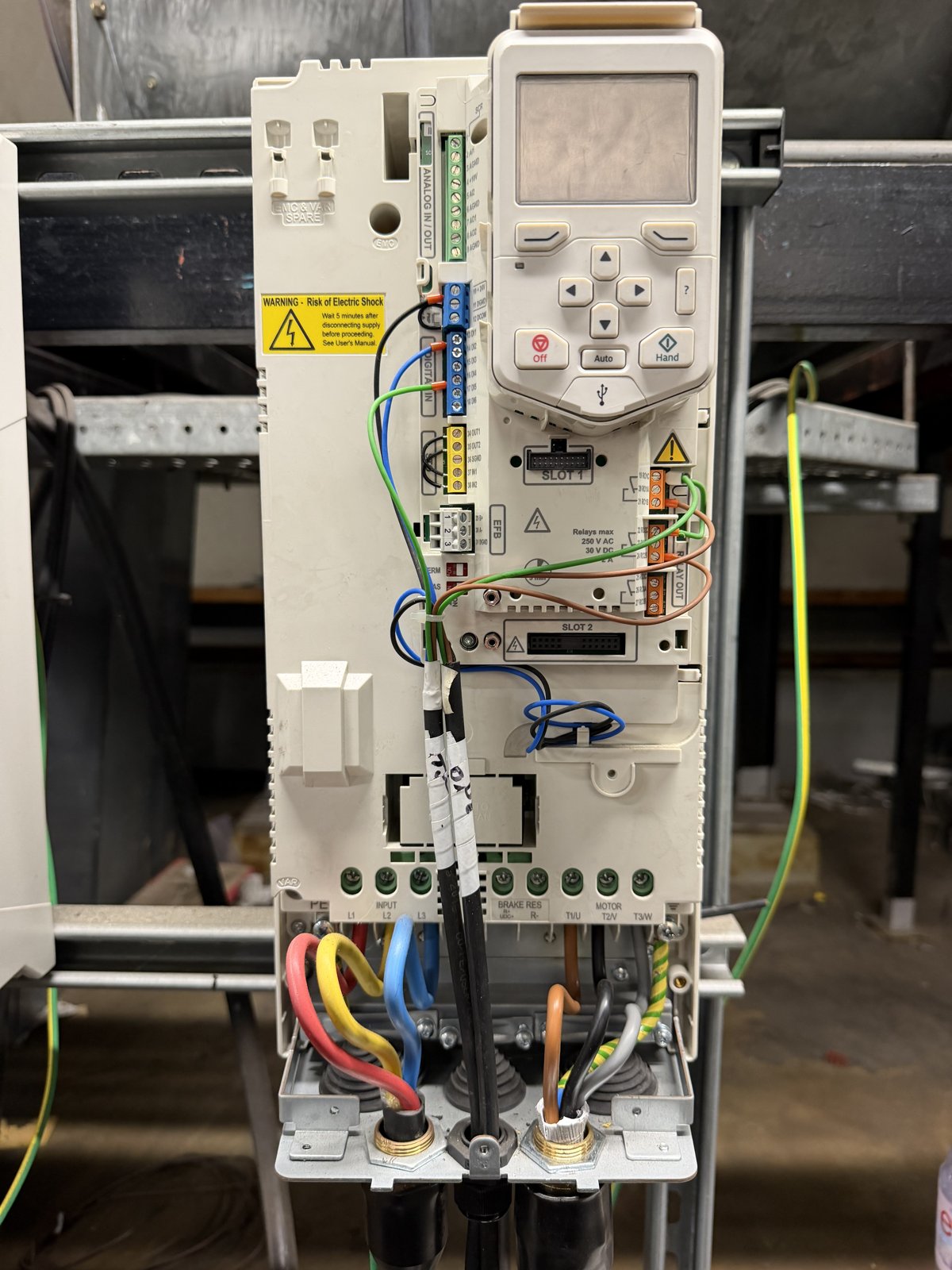 ABB ACH580 drive with cover removed showing the INPUT L1 L2 L3 terminals and the MOTOR T1/U T2/V T3/W output terminals