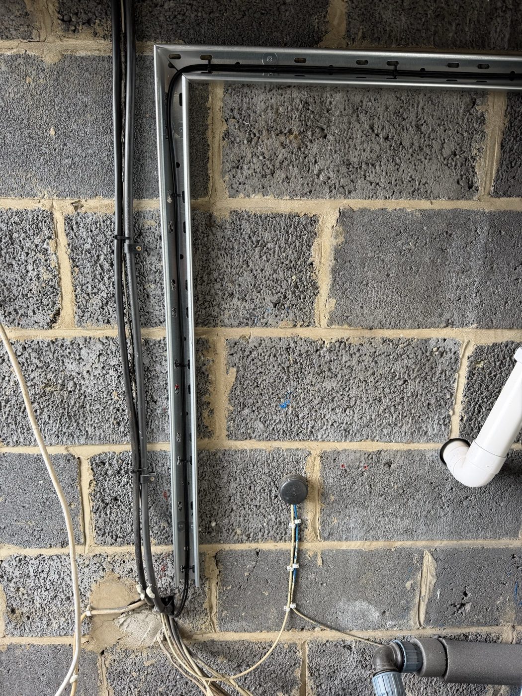 Duct-grade cable dressed along new cable tray and conduit for a cold water tank level sensor installation