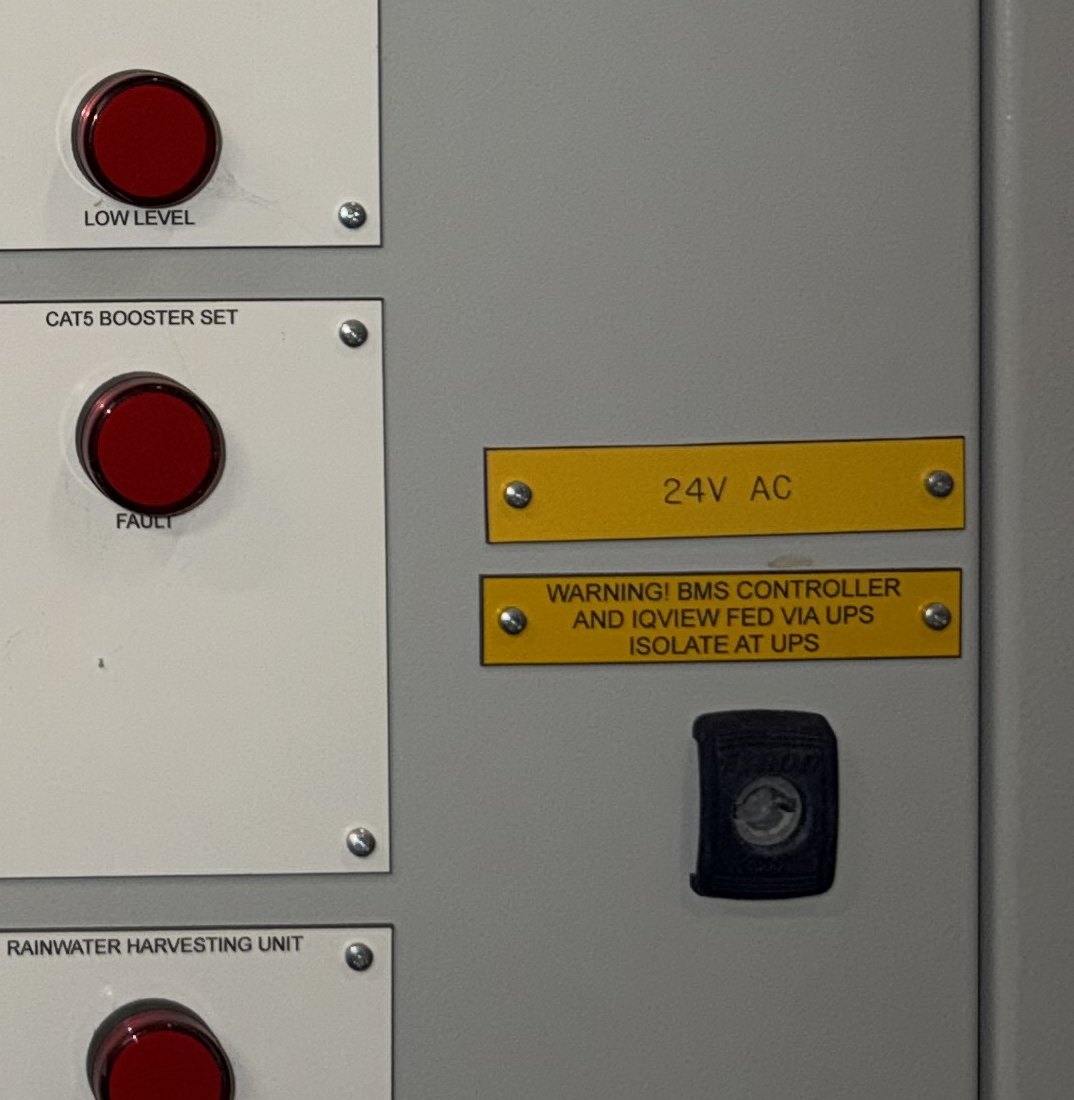 Panel warning label reading BMS controller and IQView fed via UPS, isolate at UPS