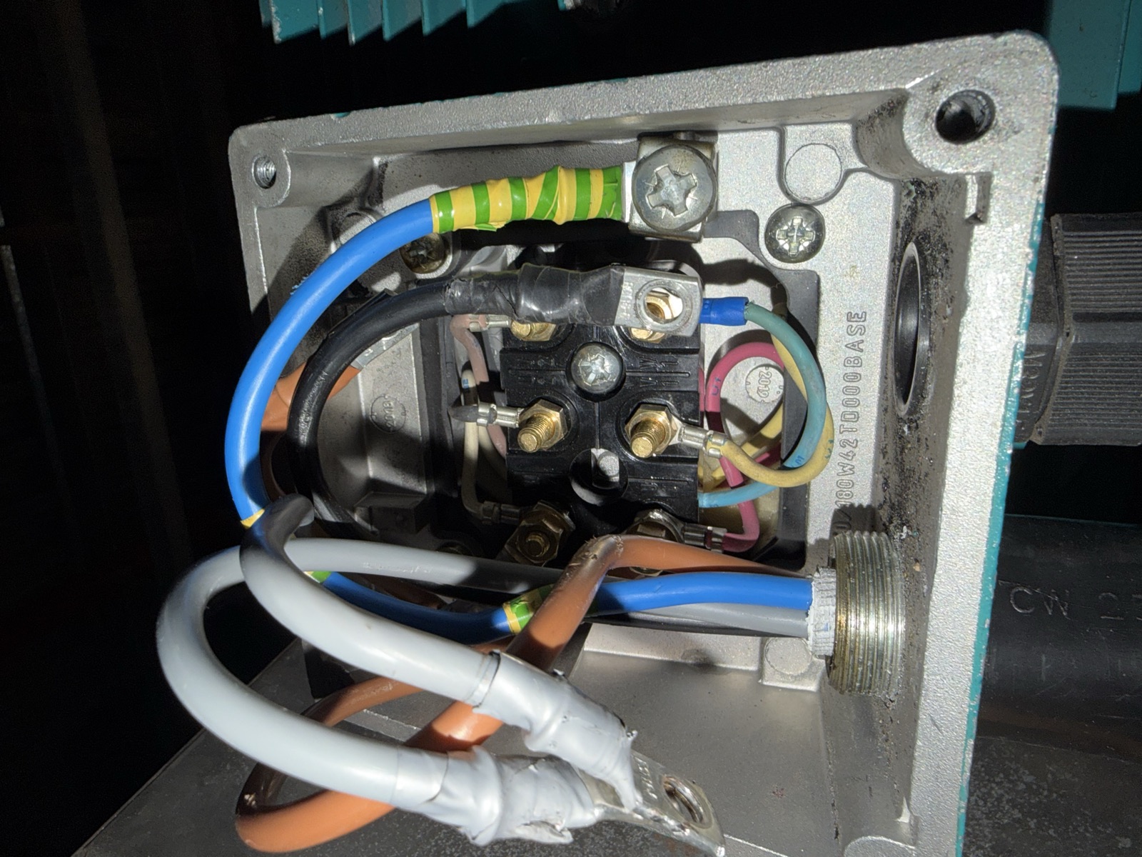 Motor terminal box with linking strips removed for individual winding testing