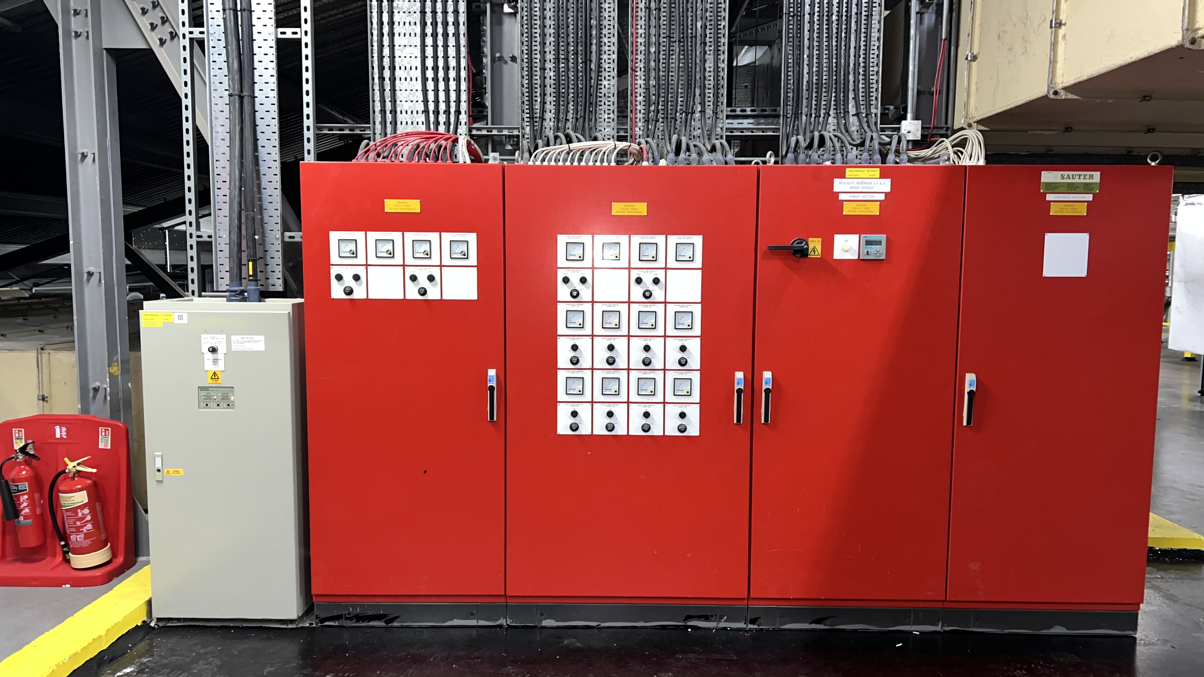 Four red electrical control panels with inverter displays