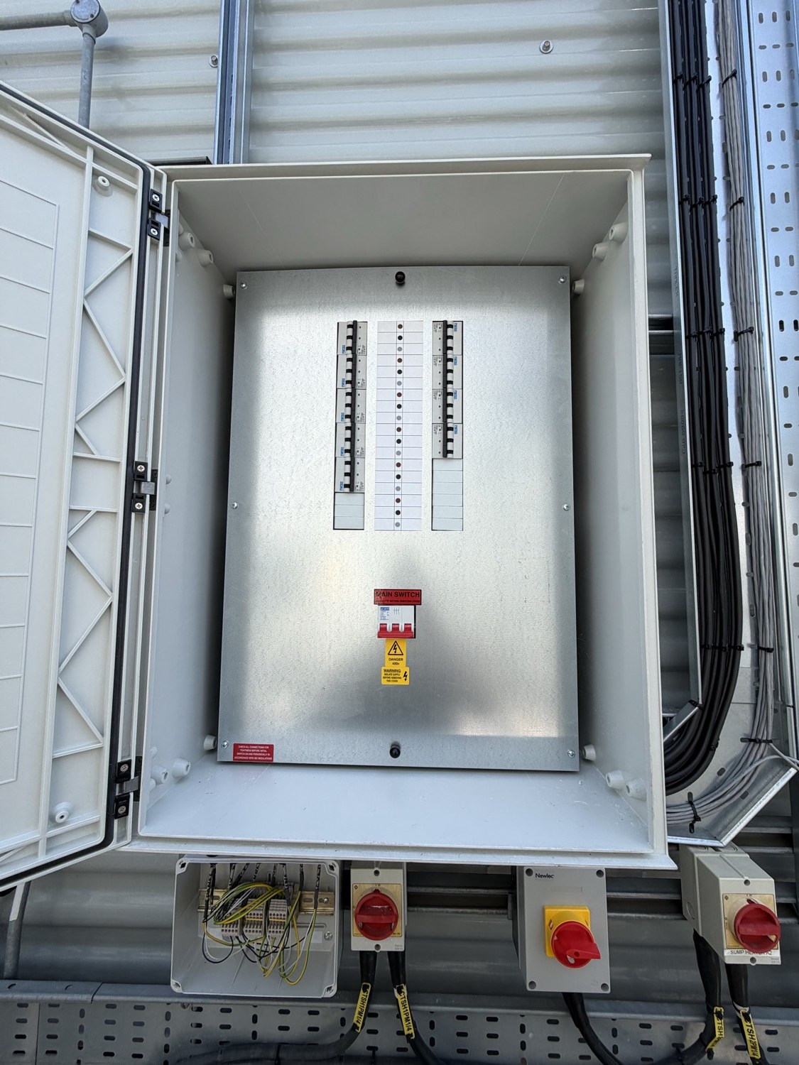 GRP distribution board with main switch and MCBs feeding one cell of cooling-tower fans at the Park Royal data centre