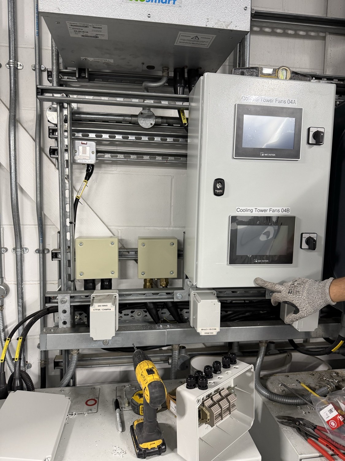 Data centre BMS integration — new cooling-tower fan control panel with twin touchscreens at a live Park Royal data centre